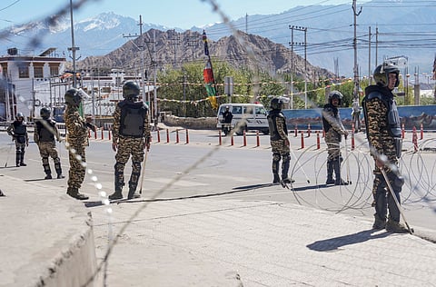 Security personnel stand guard on a road amid curfew, days after violence during protests for Ladakh statehood, in Leh, Monday, Sept. 29, 2025.