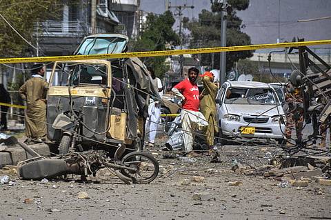 Rescue workers and security officials examine damaged vehicles at the site of a powerful car bombing, in Quetta, Pakistan, Tuesday, Sept. 30, 2025.