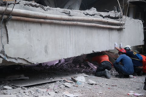 Rescuers search for victims at the site where a building under construction collapsed at an Islamic boarding school in Sidoarjo, East Java, Indonesia, Tuesday, Sept. 30, 2025.