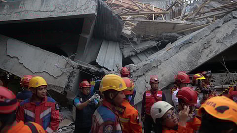 Rescuers search for victims at the site where a building under construction collapsed at an Islamic boarding school in Sidoarjo, East Java, Indonesia, Tuesday, Sept. 30, 2025.