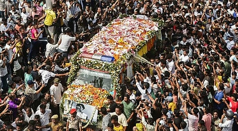 People gather as the mortal remains of singer Zubeen Garg being taken to his residence from the Guwahati airport.