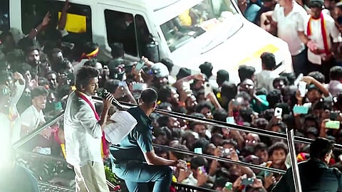 In this image from Sep. 27, 2025, Tamilaga Vettri Kazhagam chief and actor Vijay addresses a gathering before a stampede during a public event, in Karur.