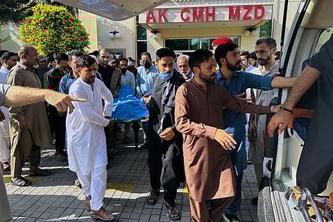 People transport the body of a person, who was killed in the clashes between police and demonstrators demanding subsidies on food, cheaper electricity and other concession, at a hospital in Muzaffarabad, the capital of Pakistani controlled Kashmir,