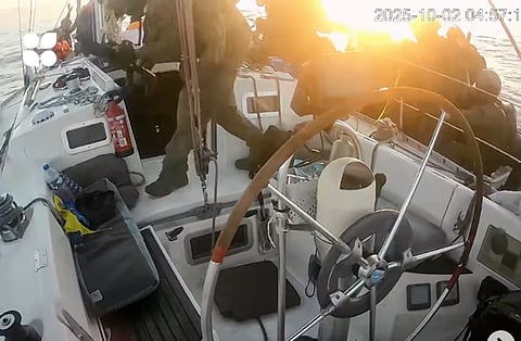 This frame grab from video released by the Global Sumud Flotilla shows as Israeli Navy soldiers board one of the flotilla vessels as they approach of the coast of Gaza early Thursday, Oct 2, 2025