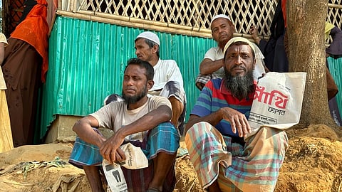 Rohingya refugees wait for food to be distributed during the Islamic holy month of Ramadan at their camp in Cox's Bazar, Bangladesh, March 6, 2025.