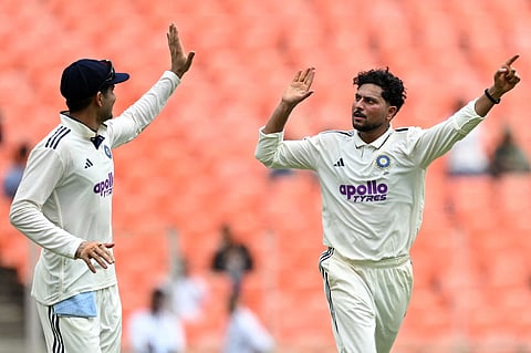 Kuldeep Yadav (R) celebrates the wicket of Shai Hope with India captain Shubman Gill on Thursday