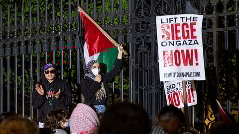 Leqaa Kordia, right, demonstrates with pro-Palestianian protesters as they gather near a main gate at Columbia University in New York, Tuesday, April 30, 2024, just before New York City police officers cleared the area after a building was taken over by protesters earlier in the day.
