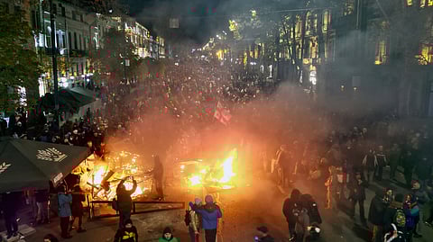 Protesters pour into the streets outside the parliament building in Tbilisi, Georgia, on Friday, Nov. 29, 2024.