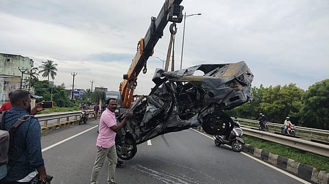 Mangled remains of the car being removed from the accident site.