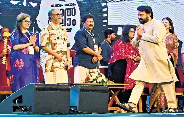 Mohanlal walks towards the stage at the 'Malayalam Vanolam, Lal Salam' event at Central Stadium in Thiruvananthapuram on Saturday. Director of Cultural Department Divya S Iyer, actors Madhupal, Prem Kumar, Renjini and Malavika Mohanan are also seen.