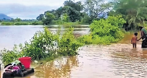 A submerged road after flood in Hati river and boulders blocking Mukhiguda-Mahulpatna ghat road