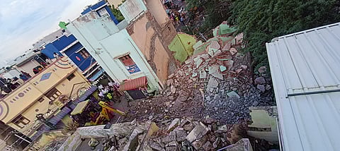 The collapse occurred while the woman was waiting under the building and the children were playing nearby.