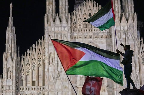Pro-Palestinian demonstrators wave Palestinian flags in front of Milan's Duomo Gothic Cathedral in northern Italy, Thursday, Oct. 2, 2025, during a march to protest after Israeli Defense Forces intercepted a Gaza-bound aid flotilla in the Mediterranean Sea on Wednesday.