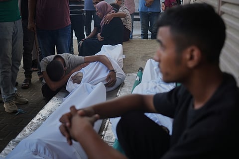 Mourners attend the funeral of Palestinians killed in an Israeli army strike, outside Al-Aqsa Hospital in Deir al-Balah, central Gaza Strip, Saturday, Oct. 4, 2025.