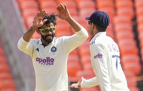 India's Ravindra Jadeja celebrates with captain Shubman Gill after taking the wicket of West Indies' Brandon King during the third day of the first Test cricket match between India and West Indies, in Ahmedabad, Gujarat, Saturday, Oct. 4, 2025.