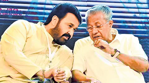 Actor Mohanlal and Chief Minister Pinarayi Vijayan sharing a light moment at the event