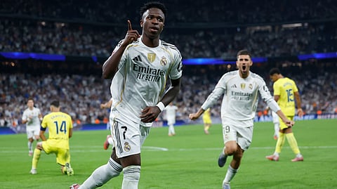 Real Madrid's forward Vinicius Junior celebrates scoring the opening goal during the Spanish league football match between Real Madrid CF and Villarreal CF at the Santiago Bernabeu stadium in Madrid on October 4, 2025.