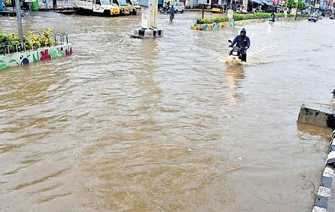 The temple town of Tirupati presents a grim spectacle with vehicle users facing inconvenience to navigate submerged roads after downpour on Saturday .