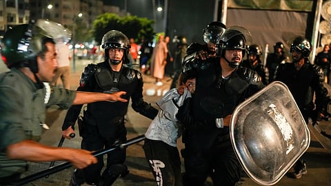 A boy is detained as youth led protests calling for healthcare and education reforms turned violent, in Sale, Morocco, Wednesday, Oct. 1, 2025