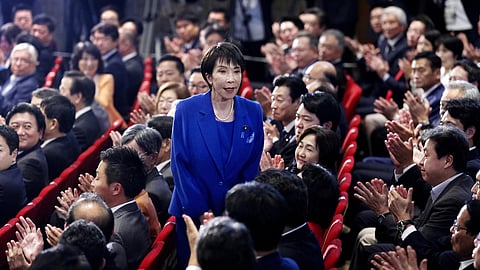 Former Economic Security Minister Sanae Takaichi, center, stands as Takaichi was chosen to a new leader of Japan’s ruling Liberal Democratic Party during the party's leadership election in Tokyo, Japan, Saturday, Oct. 4, 2025.