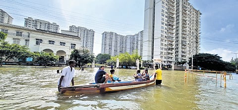 Residents wading through the severely waterlogged Semmancheri and DLF City regions of Chennai during the 2021 floods