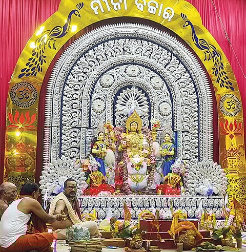 The idol of Goddess Laxmi and the pandal of Mina Bazar Puja Committee in Dhenkanal town decorated with 1 kg gold and 140 kg silver.