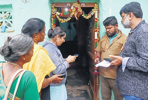 An enumerator collects details from the members of a family in Bengaluru on Saturday.