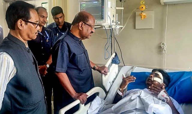 West Bengal Governor CV Ananda Bose meets BJP MP Khagen Murmu after he was attacked by a mob in Jalpaiguri district's Nagrakata area while visiting relief sites, in Siliguri, Tuesday, Oct. 7, 2025.