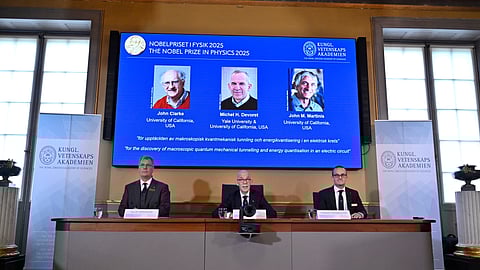 From left, Chair of the Nobel Committee for Physics Chair Olle Eriksson, Secretary General of the Swedish Academy of Sciences Hans Ellegren and Member of the Nobel Committee for Physics Goran Johansson announce John Clarke, Michel H Devoret and John M. Martinis, on screen behind, as the recipients the Nobel Prize in Physics, at the Nobel Assembly of the Karolinska Institutet, in Stockholm, Sweden, Tuesday, Oct. 7, 2025.
