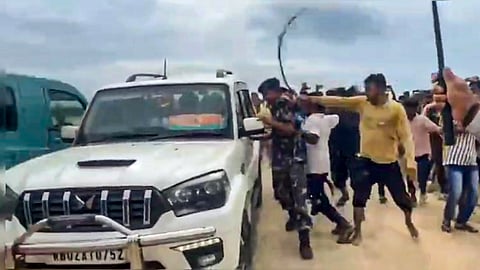 People attack the convoy of BJP MP Khagen Murmu during his visit to the flood-affected Nagrakata area, in Jalpaiguri district, West Bengal, Monday, Oct. 6, 2025.