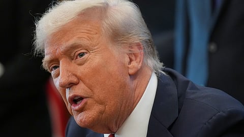 President Donald Trump speaks to reporters before signing an executive order in the Oval Office at the White House, Monday, Oct. 6, 2025.