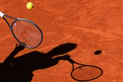 A player casts a shadow upon the court as they play a shot during the French Tennis Open, Friday, May 30, 2025, at the Roland-Garros stadium in Paris.