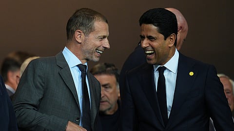 UEFA President Aleksander Ceferin, left, and PSG president Nasser Al-Khelaifi laugh before the Champions League opening phase soccer match between Barcelona and Paris Saint-Germain at the Lluis Companys Olympic Stadium in Barcelona, Spain, Wednesday, Oct. 1, 2025.