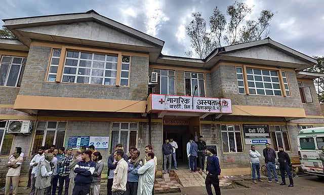 Family members of victims outside a hospital after a massive landslide hit a private bus, in Bilaspur district of Himachal Pradesh, Wednesday, Oct. 8, 2025.