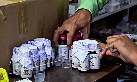 The Drugs Department sealing the Coldrif cough syrup containers after 10 children allegedly die due to consuming it during raid in an Ayush firm, in Chhindwara on Sunday.