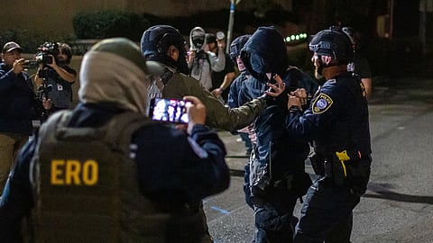 A protester is arrested by police and federal officers outside a US Immigration and Customs Enforcement facility in Portland, Ore., Monday, Oct. 6, 2025.