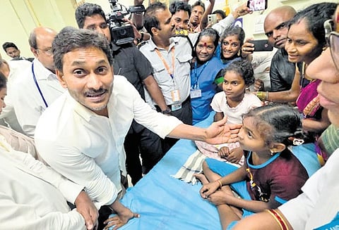 Former CM and YSRC president Jagan Mohan Reddy interacts with the students undergoing treatment for jaundice at KGH hospital on Thursday.