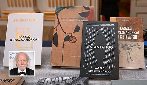 Books of Hungarian writer Laszlo Krasznahorkai (inset), the winner of the 2025 Nobel Prize in Literature, on display at the Swedish Academy in Stockholm, Sweden.