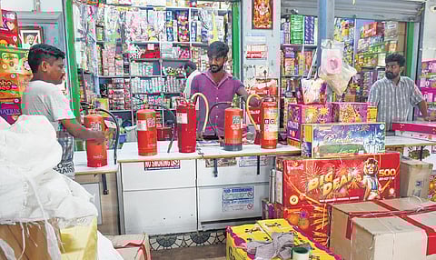 As a measure to ensure public safety, firecracker shopkeepers set up extinguishers, in Vijayawada on Thursday.