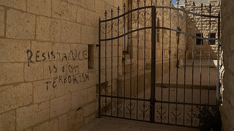 A message of resistance is written in English on a wall of an alley in the Old City of Taybeh, in the West Bank, Sept. 28, 2025.