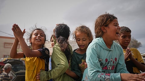 Palestinians celebrate following the announcement that Israel and Hamas have agreed to the first phase of a peace plan to pause the fighting, in Khan Younis, southern Gaza Strip, Thursday, Oct. 9, 2025. Celebrations remain limited, as relief is mixed with mourning and concern for what comes next.