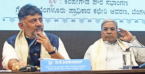 Deputy Chief Minister DK Shivakumar and Chief Minister Siddaramaiah at an official programme in Bengaluru on Friday