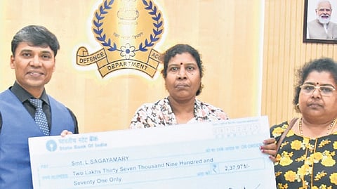 T Jayaseelan, IDAS, Controller of Defence Accounts, hands over a cheque to a beneficiary during the Defence Pensioners Grievance Day at the CDA office on Wednesday
