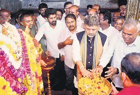 Deputy Chief Minister DK Shivakumar, MLA KY Nanje Gowda and others offer prayers at Marikamba temple in Malur late on Thursday night.