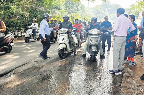 Central City Corporation Commissioner Rajendra Cholan (in blue shirt) inspects a road during his Shivajinagar rounds on Thursday