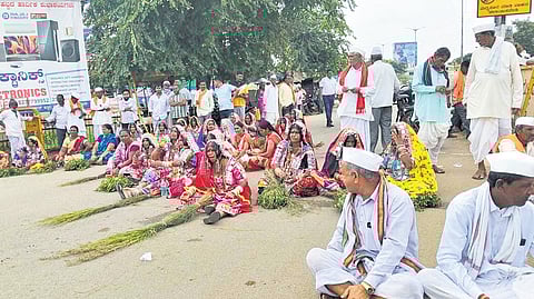 Banjara community members hold a broomstick protest in Gadag on Saturday