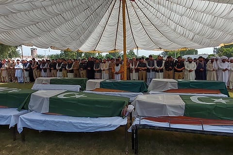 Officials and other attend funeral prayers of police officers, who were killed when gunmen attacked a police training center, in Dera Ismail Khan in northwestern Pakistan, Saturday, Oct 11, 2025.