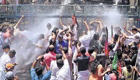 Police using water cannons to disperse BJP workers who took out a protest march to the office of Devaswom Minister V N Vasavan in Ettumanoor on Saturday