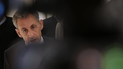 Former French President Nicolas Sarkozy pauses as he speaks with the media after a Paris court sentenced him to 5 years after finding him guilty of criminal conspiracy in an alleged scheme to finance his 2007 campaign with funds from Libya, Thursday, Sept. 25, 2025, in Paris.