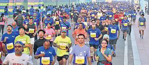People take part in the ‘Delhi Half Marathon’ at Kartavya Path